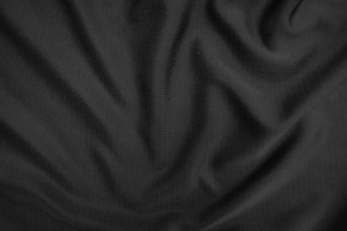 Arkaplan dokusu siyah kumaş. Soyut koyu dalgalı yumuşak. Kumaş kırışmış. Lüks moda tarzı..