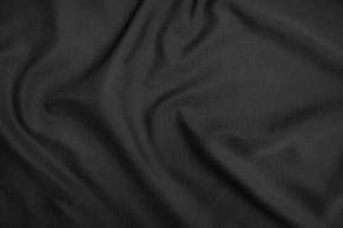Arkaplan dokusu siyah kumaş. Soyut koyu dalgalı yumuşak. Kumaş kırışmış. Lüks moda tarzı..
