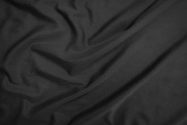 Arkaplan dokusu siyah kumaş. Soyut koyu dalgalı yumuşak. Kumaş kırışmış. Lüks moda tarzı..