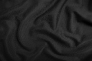 Arkaplan dokusu siyah kumaş. Soyut koyu dalgalı yumuşak. Kumaş kırışmış. Lüks moda tarzı..