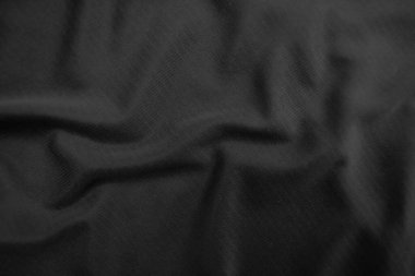 Arkaplan dokusu siyah kumaş. Soyut koyu dalgalı yumuşak. Kumaş kırışmış. Lüks moda tarzı..