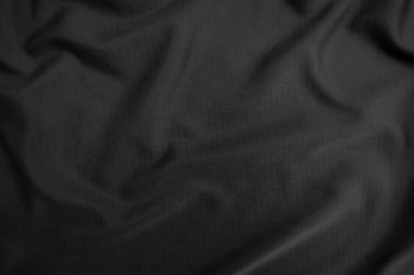 Arkaplan dokusu siyah kumaş. Soyut koyu dalgalı yumuşak. Kumaş kırışmış. Lüks moda tarzı..
