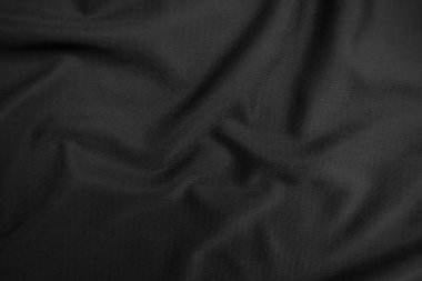 Arkaplan dokusu siyah kumaş. Soyut koyu dalgalı yumuşak. Kumaş kırışmış. Lüks moda tarzı..