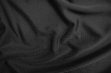 Arkaplan dokusu siyah kumaş. Soyut koyu dalgalı yumuşak. Kumaş kırışmış. Lüks moda tarzı..