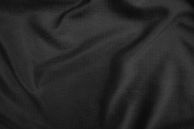 Arkaplan dokusu siyah kumaş. Soyut koyu dalgalı yumuşak. Kumaş kırışmış. Lüks moda tarzı..