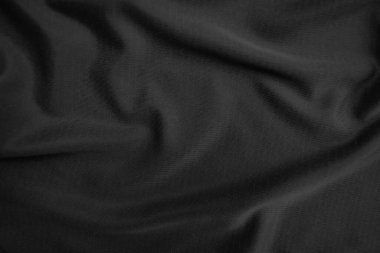 Arkaplan dokusu siyah kumaş. Soyut koyu dalgalı yumuşak. Kumaş kırışmış. Lüks moda tarzı..