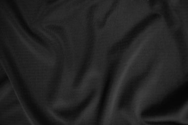 Arkaplan dokusu siyah kumaş. Soyut koyu dalgalı yumuşak. Kumaş kırışmış. Lüks moda tarzı..