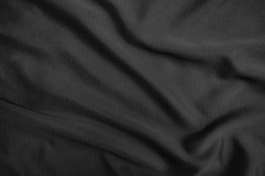 Arkaplan dokusu siyah kumaş. Soyut koyu dalgalı yumuşak. Kumaş kırışmış. Lüks moda tarzı..