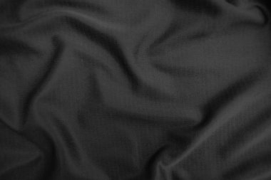 Arkaplan dokusu siyah kumaş. Soyut koyu dalgalı yumuşak. Kumaş kırışmış. Lüks moda tarzı..