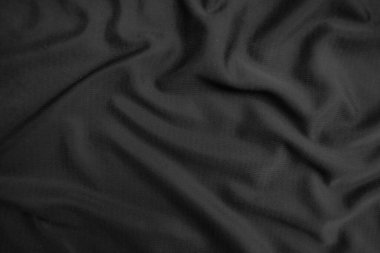 Arkaplan dokusu siyah kumaş. Soyut koyu dalgalı yumuşak. Kumaş kırışmış. Lüks moda tarzı..