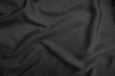 Arkaplan dokusu siyah kumaş. Soyut koyu dalgalı yumuşak. Kumaş kırışmış. Lüks moda tarzı..
