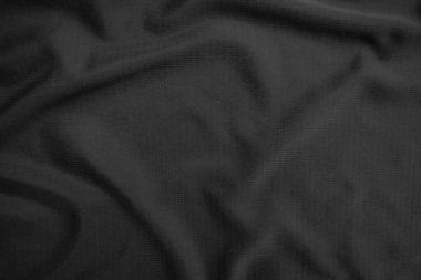 Arkaplan dokusu siyah kumaş. Soyut koyu dalgalı yumuşak. Kumaş kırışmış. Lüks moda tarzı..