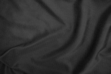 Arkaplan dokusu siyah kumaş. Soyut koyu dalgalı yumuşak. Kumaş kırışmış. Lüks moda tarzı..