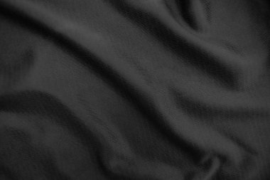 Arkaplan dokusu siyah kumaş. Soyut koyu dalgalı yumuşak. Kumaş kırışmış. Lüks moda tarzı..
