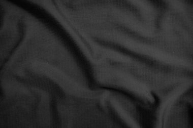 Arkaplan dokusu siyah kumaş. Soyut koyu dalgalı yumuşak. Kumaş kırışmış. Lüks moda tarzı..