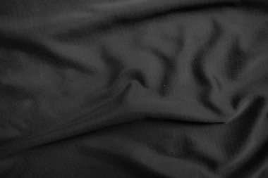 Arkaplan dokusu siyah kumaş. Soyut koyu dalgalı yumuşak. Kumaş kırışmış. Lüks moda tarzı..