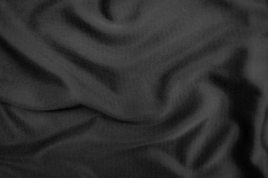 Arkaplan dokusu siyah kumaş. Soyut koyu dalgalı yumuşak. Kumaş kırışmış. Lüks moda tarzı..