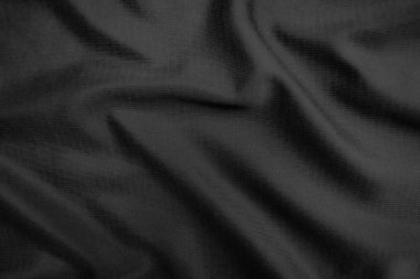 Arkaplan dokusu siyah kumaş. Soyut koyu dalgalı yumuşak. Kumaş kırışmış. Lüks moda tarzı..