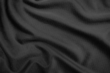 Arkaplan dokusu siyah kumaş. Soyut koyu dalgalı yumuşak. Kumaş kırışmış. Lüks moda tarzı..