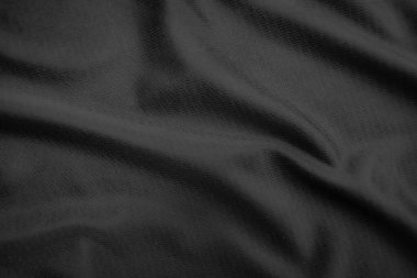 Arkaplan dokusu siyah kumaş. Soyut koyu dalgalı yumuşak. Kumaş kırışmış. Lüks moda tarzı..
