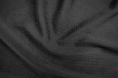Arkaplan dokusu siyah kumaş. Soyut koyu dalgalı yumuşak. Kumaş kırışmış. Lüks moda tarzı..