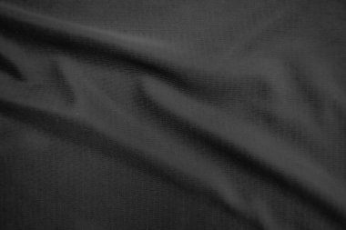 Arkaplan dokusu siyah kumaş. Soyut koyu dalgalı yumuşak. Kumaş kırışmış. Lüks moda tarzı..