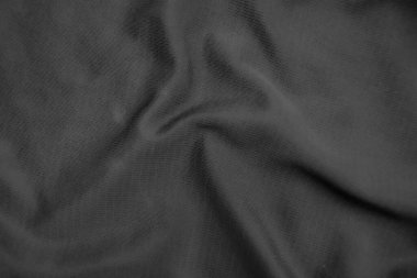 Arkaplan dokusu siyah kumaş. Soyut koyu dalgalı yumuşak. Kumaş kırışmış. Lüks moda tarzı..