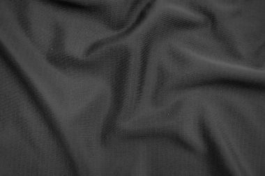 Arkaplan dokusu siyah kumaş. Soyut koyu dalgalı yumuşak. Kumaş kırışmış. Lüks moda tarzı..