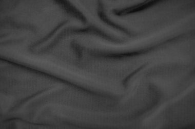 Arkaplan dokusu siyah kumaş. Soyut koyu dalgalı yumuşak. Kumaş kırışmış. Lüks moda tarzı..