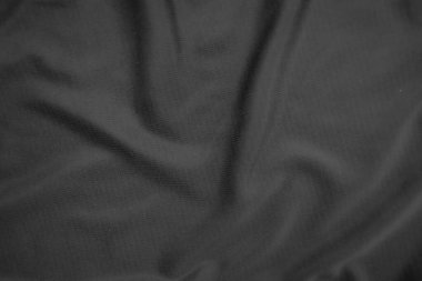 Arkaplan dokusu siyah kumaş. Soyut koyu dalgalı yumuşak. Kumaş kırışmış. Lüks moda tarzı..