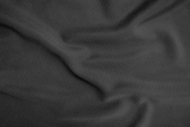 Arkaplan dokusu siyah kumaş. Soyut koyu dalgalı yumuşak. Kumaş kırışmış. Lüks moda tarzı..