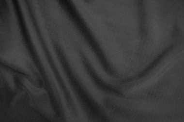 Arkaplan dokusu siyah kumaş. Soyut koyu dalgalı yumuşak. Kumaş kırışmış. Lüks moda tarzı..