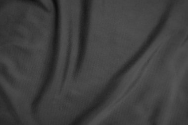 Arkaplan dokusu siyah kumaş. Soyut koyu dalgalı yumuşak. Kumaş kırışmış. Lüks moda tarzı..