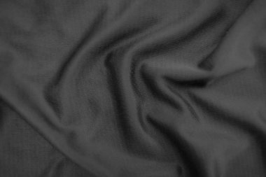 Arkaplan dokusu siyah kumaş. Soyut koyu dalgalı yumuşak. Kumaş kırışmış. Lüks moda tarzı..