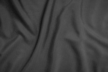 Arkaplan dokusu siyah kumaş. Soyut koyu dalgalı yumuşak. Kumaş kırışmış. Lüks moda tarzı..