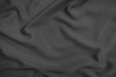 Arkaplan dokusu siyah kumaş. Soyut koyu dalgalı yumuşak. Kumaş kırışmış. Lüks moda tarzı..