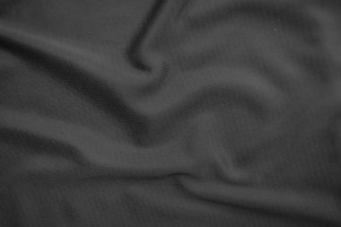 Arkaplan dokusu siyah kumaş. Soyut koyu dalgalı yumuşak. Kumaş kırışmış. Lüks moda tarzı..