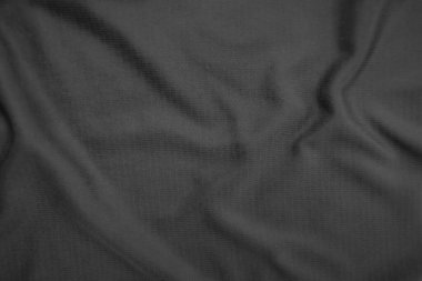 Arkaplan dokusu siyah kumaş. Soyut koyu dalgalı yumuşak. Kumaş kırışmış. Lüks moda tarzı..