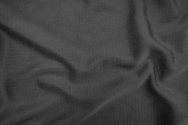 Arkaplan dokusu siyah kumaş. Soyut koyu dalgalı yumuşak. Kumaş kırışmış. Lüks moda tarzı..