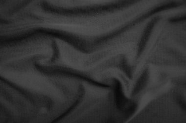 Arkaplan dokusu siyah kumaş. Soyut koyu dalgalı yumuşak. Kumaş kırışmış. Lüks moda tarzı..