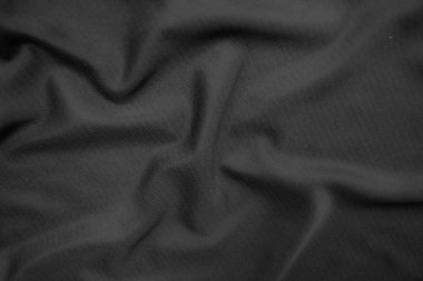 Arkaplan dokusu siyah kumaş. Soyut koyu dalgalı yumuşak. Kumaş kırışmış. Lüks moda tarzı..