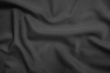 Arkaplan dokusu siyah kumaş. Soyut koyu dalgalı yumuşak. Kumaş kırışmış. Lüks moda tarzı..