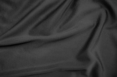 Arkaplan dokusu siyah kumaş. Soyut koyu dalgalı yumuşak. Kumaş kırışmış. Lüks moda tarzı..