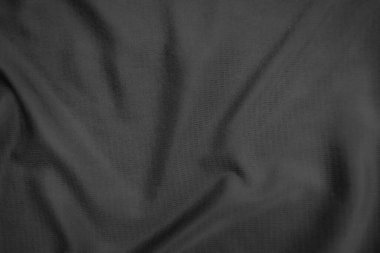 Arkaplan dokusu siyah kumaş. Soyut koyu dalgalı yumuşak. Kumaş kırışmış. Lüks moda tarzı..