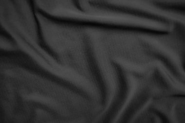 Arkaplan dokusu siyah kumaş. Soyut koyu dalgalı yumuşak. Kumaş kırışmış. Lüks moda tarzı..