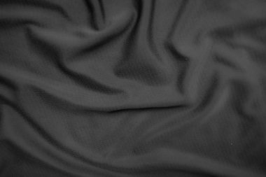 Arkaplan dokusu siyah kumaş. Soyut koyu dalgalı yumuşak. Kumaş kırışmış. Lüks moda tarzı..