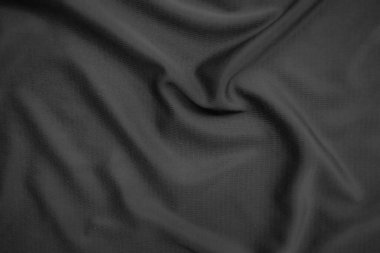 Arkaplan dokusu siyah kumaş. Soyut koyu dalgalı yumuşak. Kumaş kırışmış. Lüks moda tarzı..