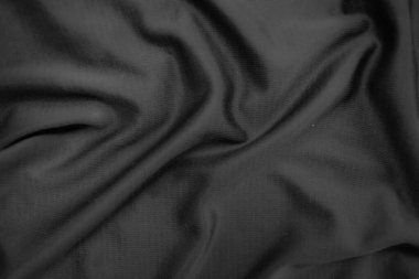 Arkaplan dokusu siyah kumaş. Soyut koyu dalgalı yumuşak. Kumaş kırışmış. Lüks moda tarzı..