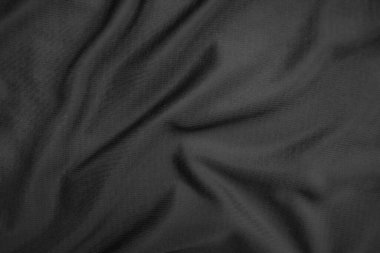 Arkaplan dokusu siyah kumaş. Soyut koyu dalgalı yumuşak. Kumaş kırışmış. Lüks moda tarzı..