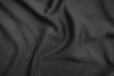 Arkaplan dokusu siyah kumaş. Soyut koyu dalgalı yumuşak. Kumaş kırışmış. Lüks moda tarzı..